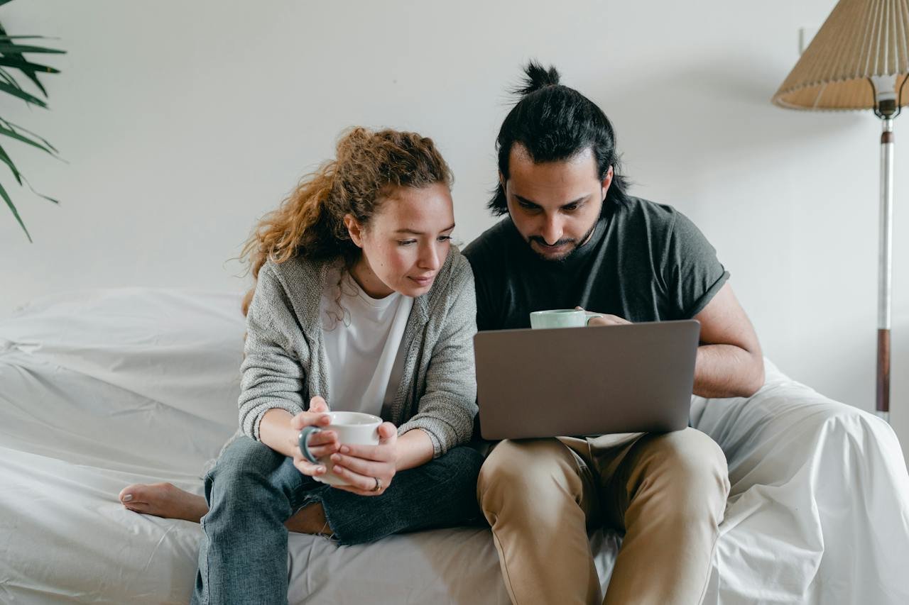 couple looking at a laptop together searching for homes